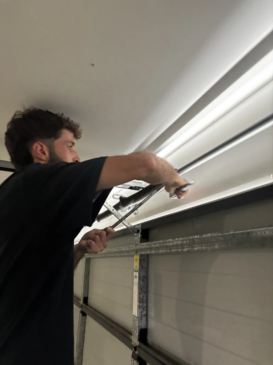 AG Doors technician adjusting garage door track hardware